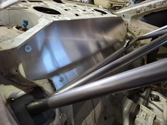 Metallic car frame with a focus on the suspension system in a workshop setting