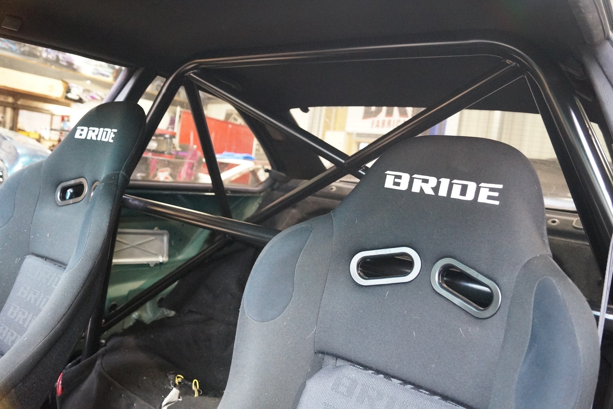 Car interior with Bride branded seats and roll cage.